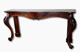 A Victorian rosewood serpentine side serving table on stout cabriole legs, carved foliate knees,