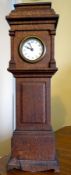 A miniature timepiece in the form of an oak longcase clock,