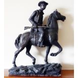 A cold cast bronzed figure of a cowboy mounted on horseback, holding rifle,