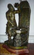A Spelter figure of a blacksmith at his forge,