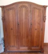 An early 20th century continental oak bedroom suite having egg and dart carved mouldings,