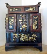 A Japanese lacquered papier mache table cabinet,