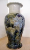 A Royal Doulton stoneware vase decorated lotus head on dark blue ground and brown band, No.