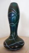 A Loetz style iridescent glass narrow-neck vase with trailed decoration,