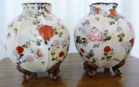 A pair of gourd shaped Japanese vases standing on four scroll feet,