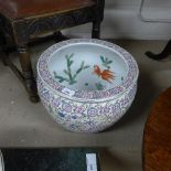 A Chinese fish bowl with enamel floral decoration with internal fish decoration