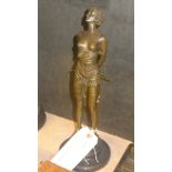 A bronzed figure of a girl with a whip