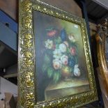 An oil on canvas still life of flowers in gilt frame