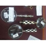 Two magnifying glasses one with checkered handle the other with baluster handle