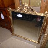 A gilted wall hanging mirror with cherub decoration