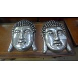 A pair of silvered Buddha wall plaques