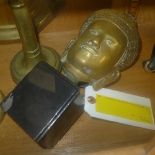 A gilt metal Oriental Buddha head on a stand