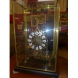 A skeleton clock within glass case