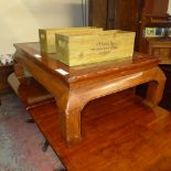 A Chinese lacquered low table with glass top and carved decoration