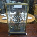 A skeleton clock within glass case