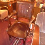 A C19th mahogany elbow chair with saddle seat and upholstered in leather (leather A/F)
