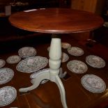 A mahogany occasional table the circular top raised on painted triform supports