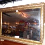 A contemporary wall mirror the rectangular plate within a gilt frame