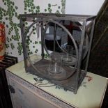 A pair of wrought metal garden candle holders with circular mirrored backs