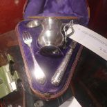 A Victorian silver Christening set consisting of a mug, spoon, knife and fork in a triangular