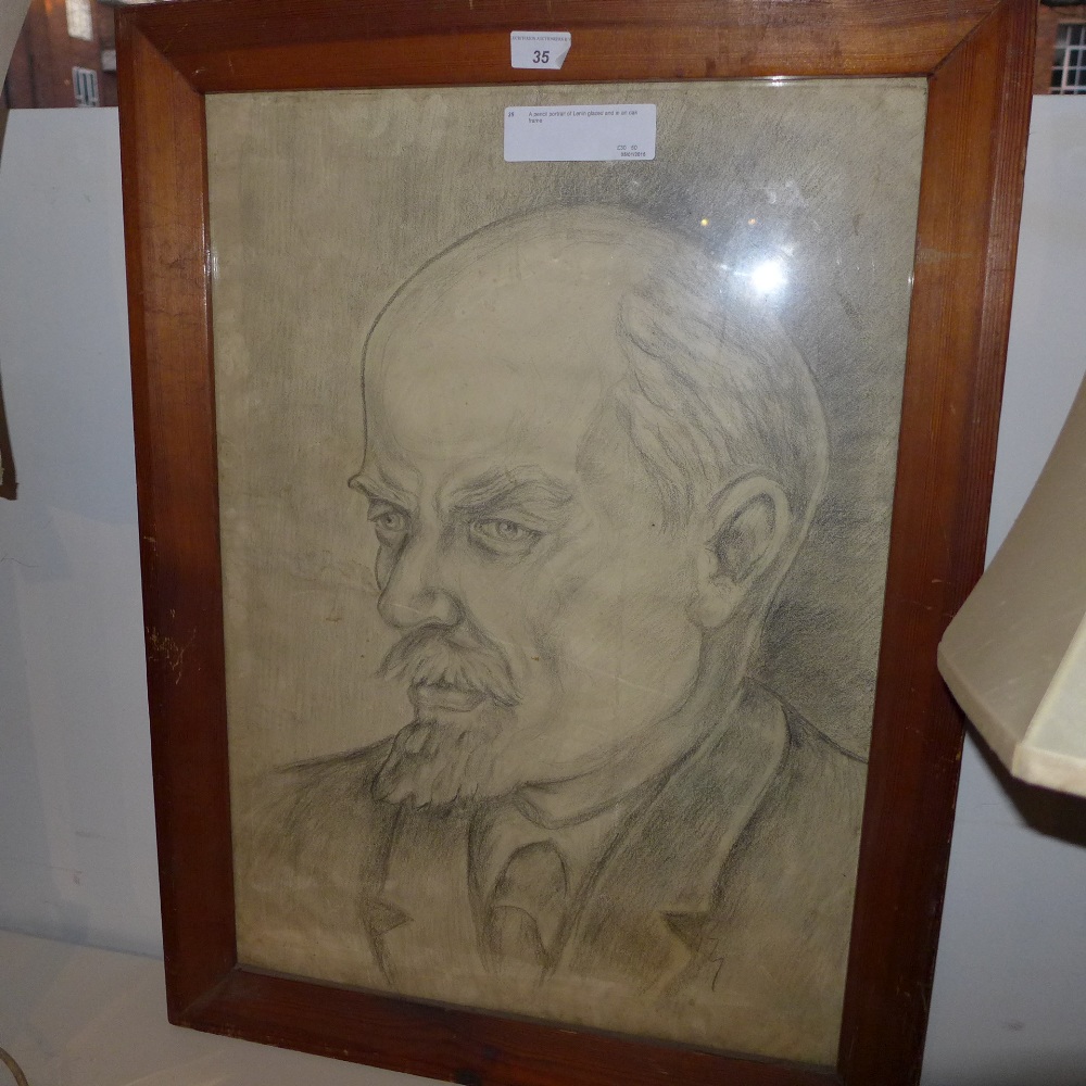 A pencil portrait of Lenin glazed and in an oak frame