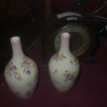 A 1950s oak cased mantel clock with circular steel dial and a pair of vases decorated with flowers