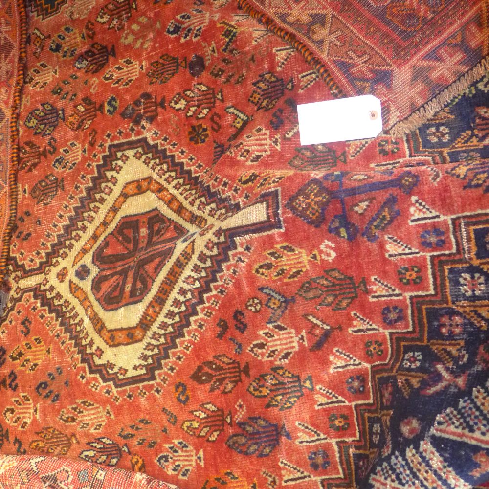 A fine South West Persian Quashgai rug 238 x 175 cm triple pole medallion on a terracotta field