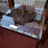 A pair of chrome low tables with inset square glass tops