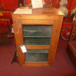 An old pine kitchen cabinet fitted single glazed panel door enclosing shelves