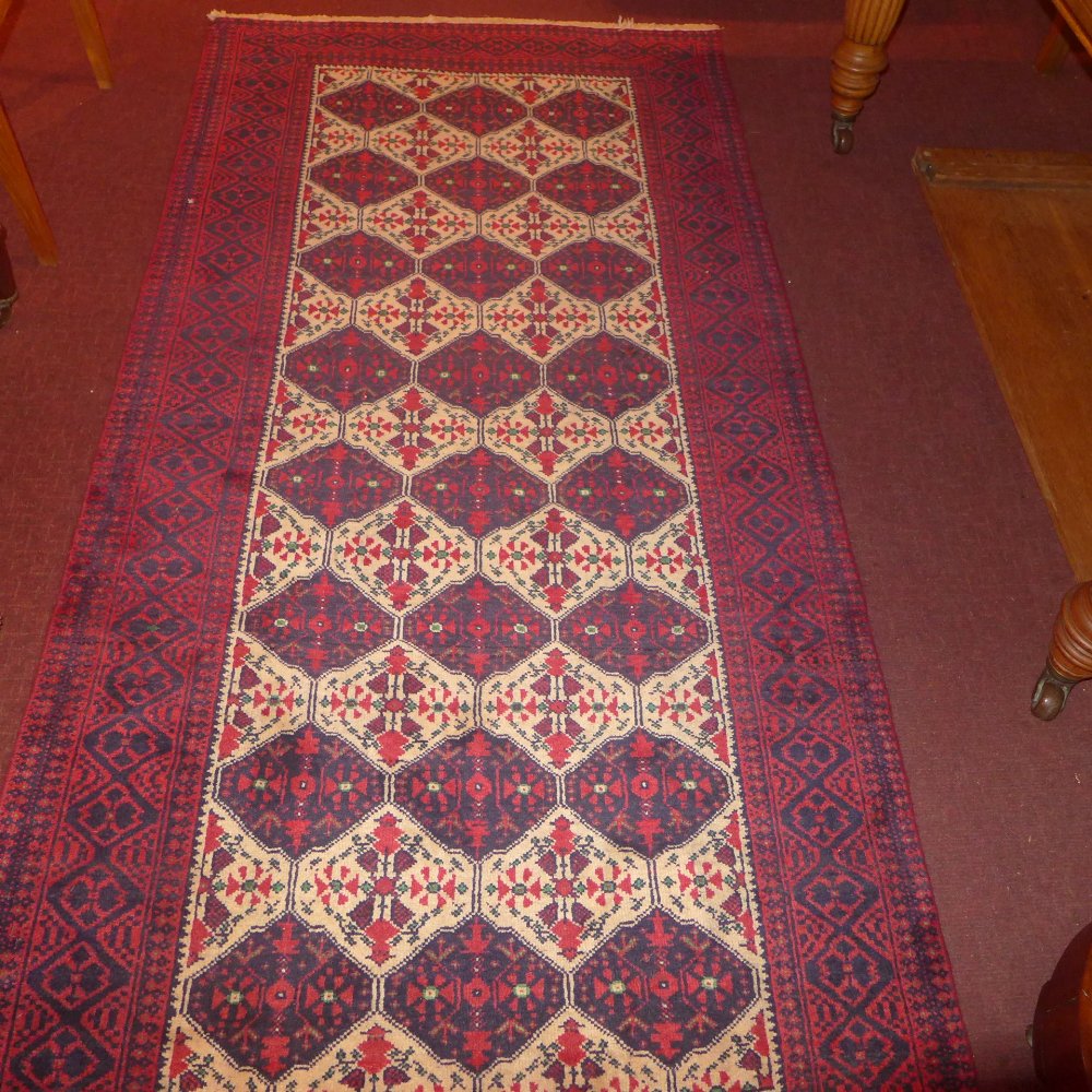 A fine North East Persian Zabir Belouch rug 230 cm x 110 cm repeating panel motifs on an ivory field