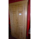 An old pine pantry cabinet of tall proportions fitted pair of panelled doors enclosing shelves