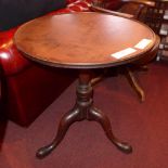 A Georgian mahogany occasional table the circular dish top raised on turned column and trform