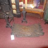 A cast iron fire grate and pair of fire dogs