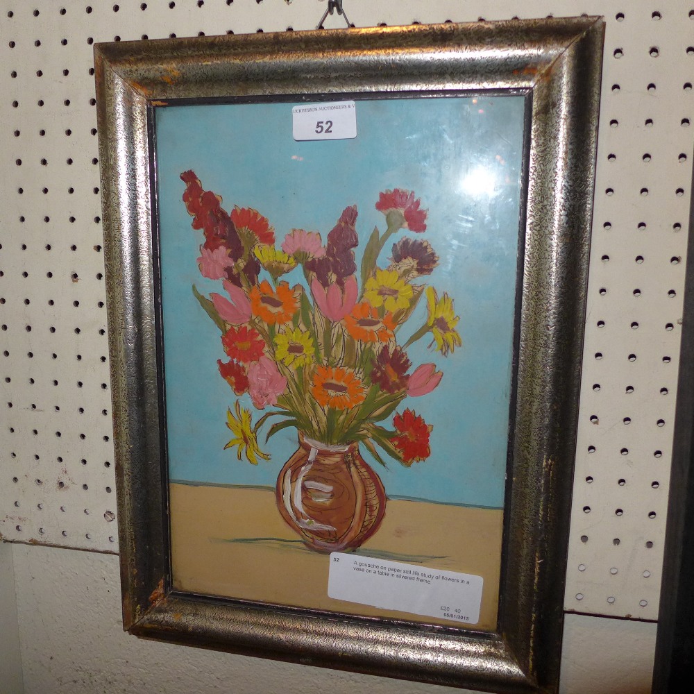 A gouache on paper still life study of flowers in a vase on a table in silvered frame