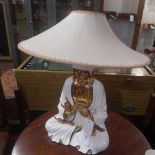 A 1950`s porcelain table lamp in the form of a meditating Buddha glazed in white and heightened in