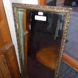 A giltwood looking glass with rectangular bevelled plate