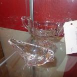 A cut glass twin handled bowl and a glass model of a dolphin on frosted glass base