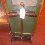 A chrome twin stickstand on cast iron supports