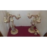 A pair of C19th Continental porcelain candelabra in the form of lady and gent heightened in gilt (