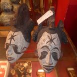 A pair of Nigerian coming of age masks having painted decoration