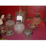 A collection of silver lidded perfume bottles, jars and similar as well as two silver plated bon bon