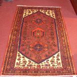 A handmade fine Persian Hamadan rug with three pole medallions on a chocolate field with ivory