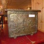 An embossed brass clad oak log bin depicting Continental domestic scenes