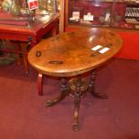 A Victorian inlaid walnut oval occasional table raised on four turned columns and quadruped