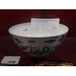 A Chinese blue and white bowl decorated with dragons and mythical birds