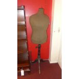 A vintage tailors dummy raised on turned column and tripod supports