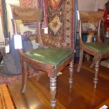 A pair of C19th mahogany bar back dining chairs upholstered in green leather on turned supports