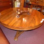 A C19th rosewood breakfast table the circular top raised on carved column and triform platform.