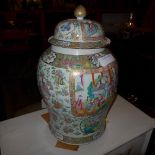 A Chinese famille rose lidded ginger jar decorated with pictoral reserves (heavily restored)