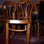 A pair of bentwood bistro chairs with solid circular seats